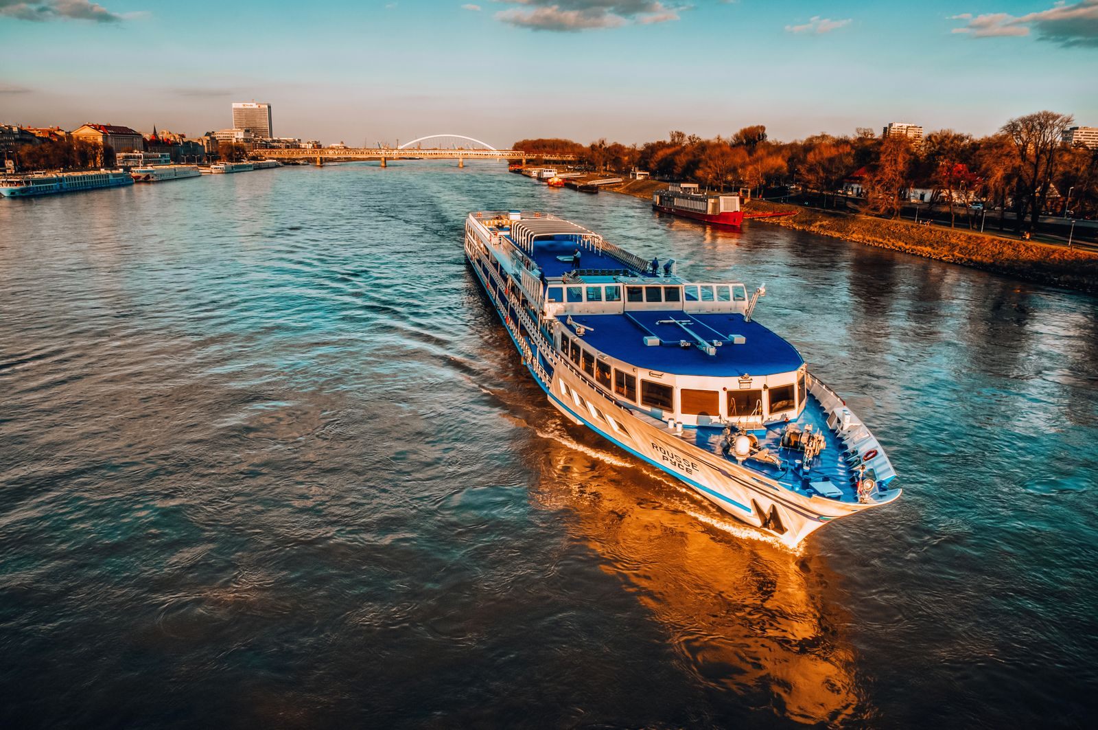 River boat on the Danube at Bratislava in golden evening light - themed river cruises